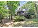 Backyard featuring screened in porch and multi-tiered deck surrounded by mature trees at 8500 Peyton Randolph Dr, Charlotte, NC 28277