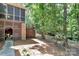 Backyard featuring lattice work under raised deck and wooded area at 8500 Peyton Randolph Dr, Charlotte, NC 28277