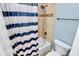Full bathroom featuring a shower with tiled walls and a decorative stripe at 8500 Peyton Randolph Dr, Charlotte, NC 28277