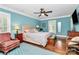 Bright bedroom featuring a ceiling fan, hardwood floors, and a large window at 8500 Peyton Randolph Dr, Charlotte, NC 28277