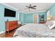 Light-filled bedroom boasting hardwood floors, blue walls, and a ceiling fan at 8500 Peyton Randolph Dr, Charlotte, NC 28277