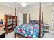 Bedroom featuring a four-poster bed, classic furnishings, and bright wallpaper at 8500 Peyton Randolph Dr, Charlotte, NC 28277