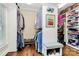 Walk-in closet with ample storage, hardwood floors, and a built-in bench at 8500 Peyton Randolph Dr, Charlotte, NC 28277
