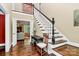 Elegant foyer with hardwood floors, staircase, and view into the living room at 8500 Peyton Randolph Dr, Charlotte, NC 28277