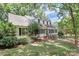 Inviting home with dormer windows surrounded by lush landscaping and a well-manicured lawn at 8500 Peyton Randolph Dr, Charlotte, NC 28277