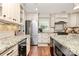 A bright kitchen features granite countertops and stainless steel appliances, including wine storage at 8500 Peyton Randolph Dr, Charlotte, NC 28277