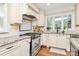 Bright eat-in kitchen with granite countertops, stainless steel appliances, and wooden floors at 8500 Peyton Randolph Dr, Charlotte, NC 28277