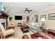 Bright living room with a fireplace, hardwood floors, and large windows at 8500 Peyton Randolph Dr, Charlotte, NC 28277