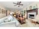 Open-concept living room with a fireplace and view into the eat-in kitchen at 8500 Peyton Randolph Dr, Charlotte, NC 28277