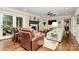Spacious living room with hardwood floors, fireplace, and a ceiling fan at 8500 Peyton Randolph Dr, Charlotte, NC 28277