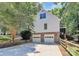 Rear of home with two-car garage, screened-in porch and well maintained fencing and landscaping at 8500 Peyton Randolph Dr, Charlotte, NC 28277