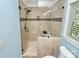 Tiled shower with glass door and window in remodeled bathroom at 8500 Peyton Randolph Dr, Charlotte, NC 28277