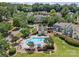 Aerial view showcases community pool with ample lounge chairs, lush landscaping, and well-maintained surrounding homes at 9136 Four Mile Creek Rd, Charlotte, NC 28277