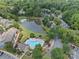 Aerial view of community featuring a pool, lake, and well-maintained landscaping amid a residential neighborhood at 9136 Four Mile Creek Rd, Charlotte, NC 28277