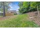 Expansive backyard with lush green grass and mature trees, perfect for outdoor activities and relaxation at 9136 Four Mile Creek Rd, Charlotte, NC 28277