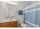 Updated bathroom with vanity, mirror and shower with blue striped curtain at 9136 Four Mile Creek Rd, Charlotte, NC 28277