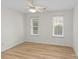 Bedroom with hardwood floors, two windows with blinds, and ceiling fan at 9136 Four Mile Creek Rd, Charlotte, NC 28277