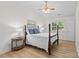 Bedroom with high ceilings, neutral colors, updated ceiling fan and hardwood flooring at 9136 Four Mile Creek Rd, Charlotte, NC 28277