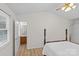 Bedroom featuring high ceilings, hardwood flooring and bathroom entrance at 9136 Four Mile Creek Rd, Charlotte, NC 28277