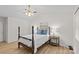 Bedroom with high ceilings, neutral colors, updated ceiling fan and hardwood flooring at 9136 Four Mile Creek Rd, Charlotte, NC 28277