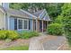 Charming blue home with brick accents, well-manicured landscaping, and inviting walkway at 9136 Four Mile Creek Rd, Charlotte, NC 28277