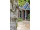 Charming brick home featuring a cozy front porch with stylish black shutters and manicured landscaping at 9136 Four Mile Creek Rd, Charlotte, NC 28277