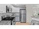 Updated kitchen features stainless steel appliances, granite countertops, and white cabinets at 9136 Four Mile Creek Rd, Charlotte, NC 28277