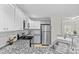 Updated kitchen boasts stainless steel appliances, granite countertops, white cabinetry, and a sink at 9136 Four Mile Creek Rd, Charlotte, NC 28277