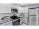 Modern kitchen includes stainless steel appliances, granite countertops, and sleek cabinetry at 9136 Four Mile Creek Rd, Charlotte, NC 28277