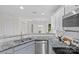 Updated kitchen boasts granite countertops and stainless steel appliances at 9136 Four Mile Creek Rd, Charlotte, NC 28277