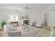 Bright living room with vaulted ceilings, fireplace, neutral decor, and wood-look floors at 9136 Four Mile Creek Rd, Charlotte, NC 28277