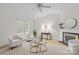 Living room with fireplace, neutral decor, ceiling fan, and wood-look flooring at 9136 Four Mile Creek Rd, Charlotte, NC 28277