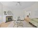 Bright living room featuring fireplace, hardwood floors, ceiling fan, and neutral decor at 9136 Four Mile Creek Rd, Charlotte, NC 28277