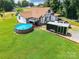 Aerial view showcasing house, in-ground pool, large lawn, and home's exterior at 106 Guffey Rd, Cherryville, NC 28021