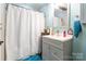 Cozy bathroom with neutral colors and a shower with a white curtain at 106 Guffey Rd, Cherryville, NC 28021