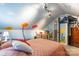 Bright bedroom featuring unique wall art, sloped ceilings, and cozy furniture for an inviting space at 106 Guffey Rd, Cherryville, NC 28021