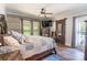Cozy bedroom with a ceiling fan, decorative barn door, wood floors, and ample natural light at 106 Guffey Rd, Cherryville, NC 28021