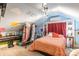 Unique bedroom with sloped ceilings, whimsical wall art, and plush bedding for a playful retreat at 106 Guffey Rd, Cherryville, NC 28021