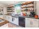 Bright kitchen showcases farmhouse sink, subway tile backsplash, open shelving, and modern appliances at 106 Guffey Rd, Cherryville, NC 28021