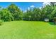 Spacious backyard with lush green grass and mature trees, offering privacy and room for recreation at 106 Guffey Rd, Cherryville, NC 28021