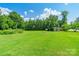 Expansive lawn with mature trees and a shed, providing ample space and outdoor storage solutions at 106 Guffey Rd, Cherryville, NC 28021