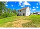 Spacious backyard featuring a gentle slope, ideal for outdoor activities, surrounded by lush greenery and trees at 107 Frank Burns Way, Kings Mountain, NC 28086