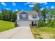 Charming two-story home featuring a classic design with a well-maintained lawn and a two car garage at 107 Frank Burns Way, Kings Mountain, NC 28086