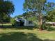 Inviting cream-colored house with blue shutters surrounded by lush green lawn and trees at 1110 Sulfur Springs Church Rd, Shelby, NC 28152