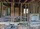 Interior of a house showing studs, brick chimney and debris, awaiting renovation at 1110 Sulfur Springs Church Rd, Shelby, NC 28152