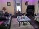 A cozy living room with a leather sofa, decorative fireplace, and unique decor at 1110 Sulfur Springs Church Rd, Shelby, NC 28152