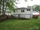 View of backyard with white siding house and some old wooden fence at 1146 Buffalo St, Shelby, NC 28150