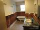 Bathroom with wood paneling, vintage style bathtub, and tile floors at 1146 Buffalo St, Shelby, NC 28150