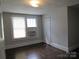 Simple bedroom with hardwood floors, closet, and windows at 1146 Buffalo St, Shelby, NC 28150