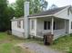 Side view of charming home featuring a large chimney and a welcoming porch at 1146 Buffalo St, Shelby, NC 28150